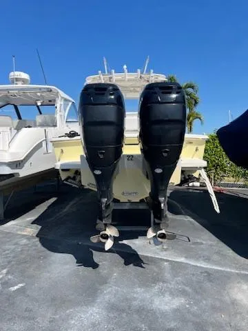  Yacht Photos Pics 2006 Jupiter 31 Center Console boat with dual outboard motors, parked on a sunny day.