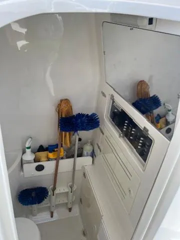  Yacht Photos Pics 2006 Jupiter 31 Center Console boat interior with cleaning supplies and storage.
