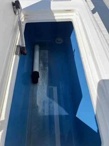  Yacht Photos Pics 2006 Jupiter 31 Center Console storage compartment with blue interior and hydraulic lift.