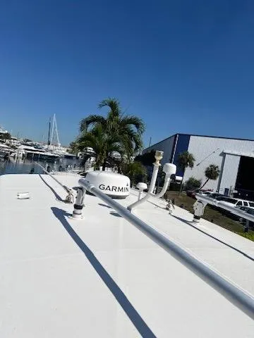  Yacht Photos Pics 2006 Jupiter 31 Center Console boat with Garmin equipment, docked near a marina.