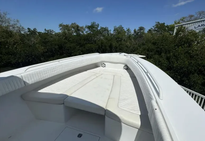  Yacht Photos Pics 2006 Jupiter 31 Center Console boat with white seating, surrounded by greenery.