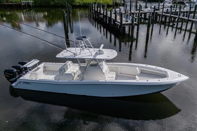  Yacht Photos Pics 2016 Invincible 39 Open Fisherman boat docked in calm waters.