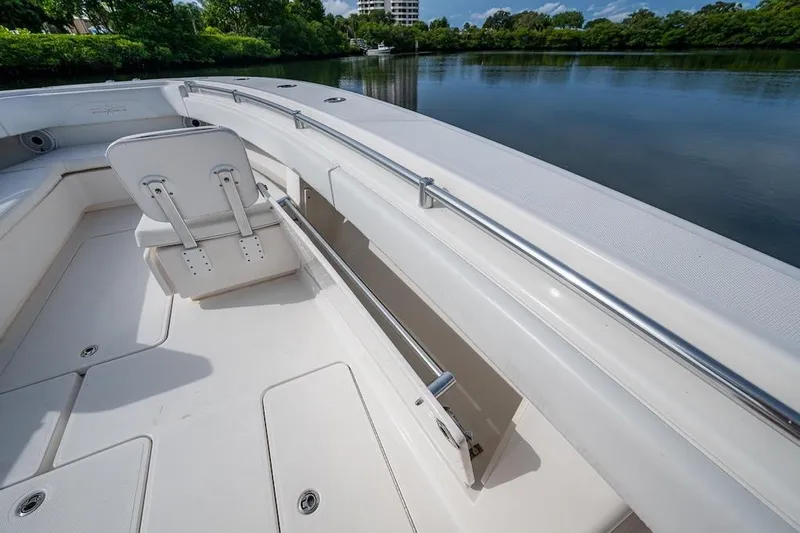  Yacht Photos Pics 2016 Invincible 39 Open Fisherman boat interior with seating and storage, docked by a serene lake.