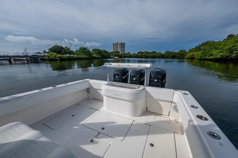  Yacht Photos Pics 2016 Invincible 39 Open Fisherman boat on calm water, featuring triple outboard engines.