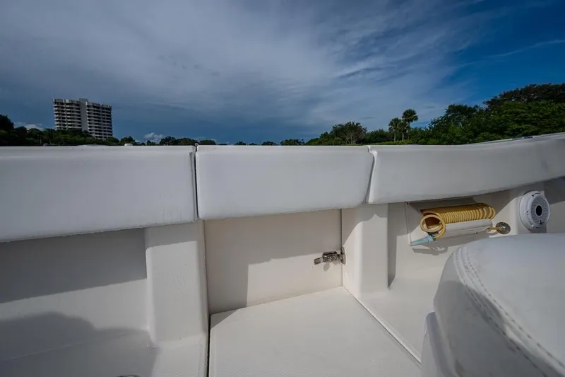  Yacht Photos Pics 2016 Invincible 39 Open Fisherman boat interior with storage compartment and scenic background.