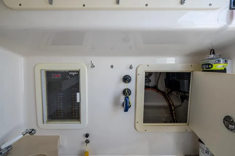  Yacht Photos Pics Interior view of 2016 Invincible 39 Open Fisherman boat's control panel and storage compartment.