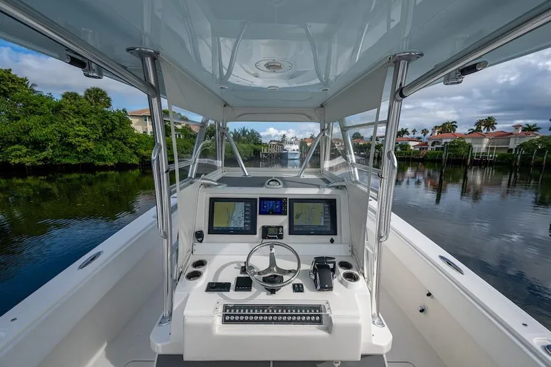 Yacht Photos Pics 2016 Invincible 39 Open Fisherman boat cockpit with navigation screens and steering wheel.