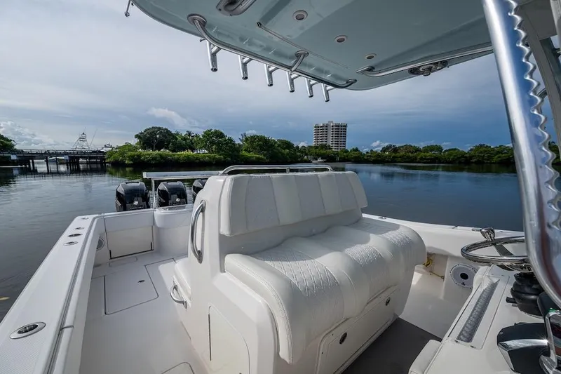  Yacht Photos Pics 2016 Invincible 39 Open Fisherman boat on calm water, featuring spacious seating and dual engines.