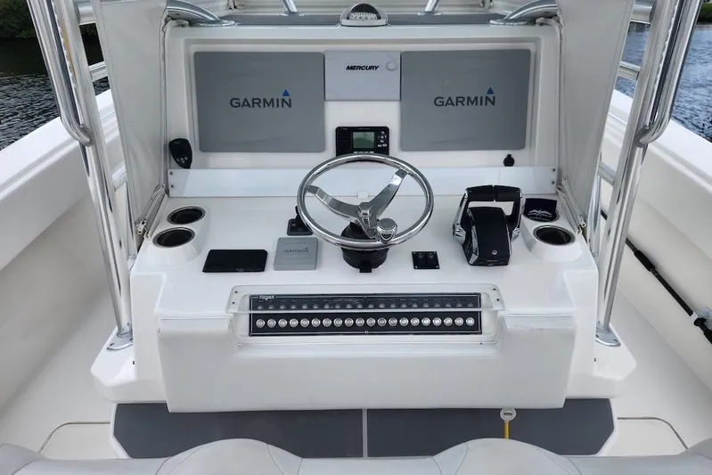  Yacht Photos Pics 2016 Invincible 39 Open Fisherman boat console with Garmin displays and steering wheel.