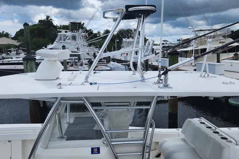  Yacht Photos Pics 2016 Invincible 39 Open Fisherman boat docked at marina under cloudy sky.