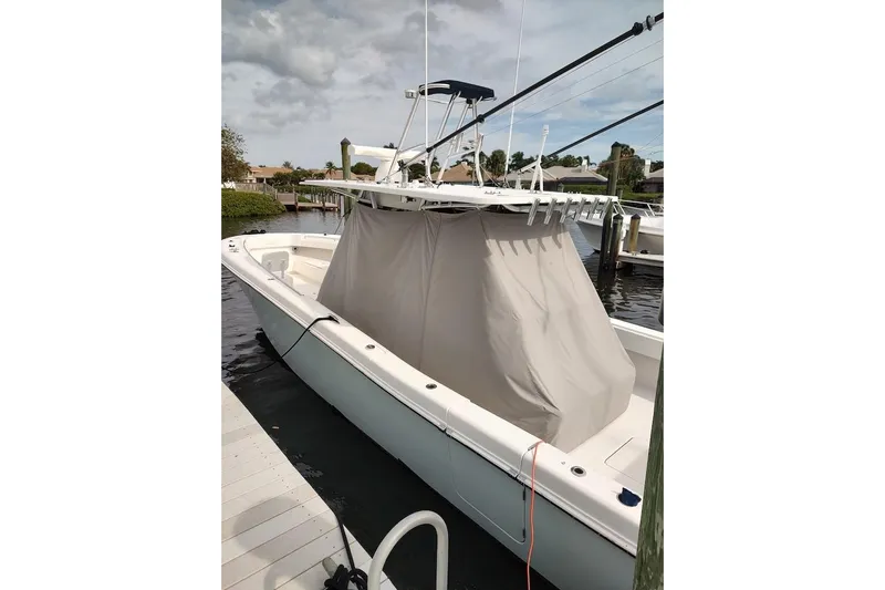  Yacht Photos Pics 2016 Invincible 39 Open Fisherman boat docked, covered, with fishing rod holders.