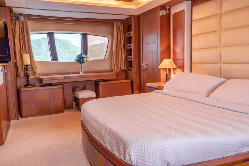 Camy Ed Yacht Photos Pics Luxurious bedroom interior of 2006 Azimut 105 Grande yacht with elegant furnishings.