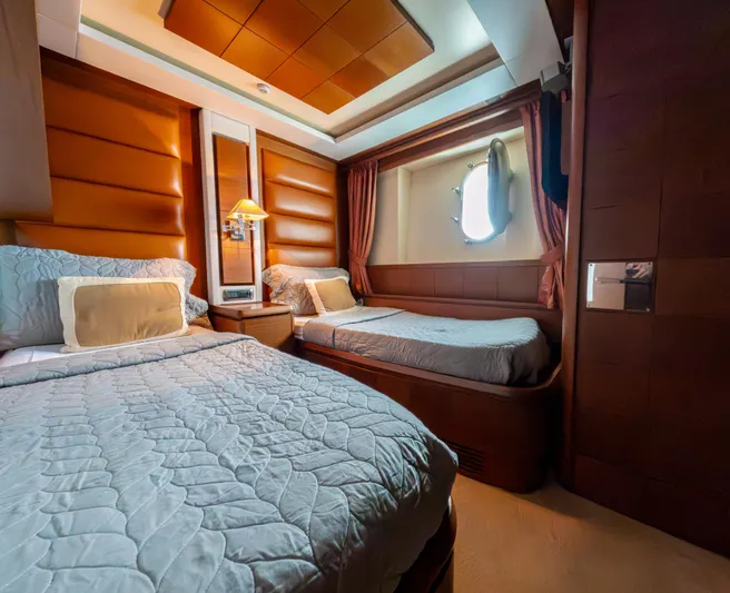 Camy Ed Yacht Photos Pics Luxurious cabin interior of 2006 Azimut 105 Grande yacht with twin beds and elegant decor.