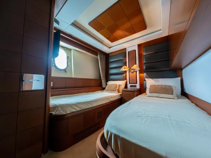 Camy Ed Yacht Photos Pics Luxurious cabin interior of 2006 Azimut 105 Grande yacht with twin beds and elegant decor.