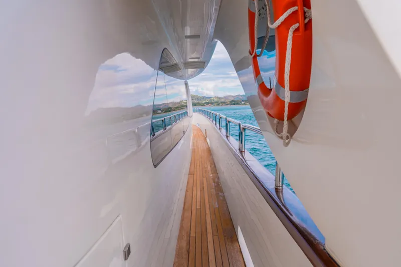 Camy Ed Yacht Photos Pics Side deck view of 2006 Azimut 105 Grande yacht with ocean backdrop.