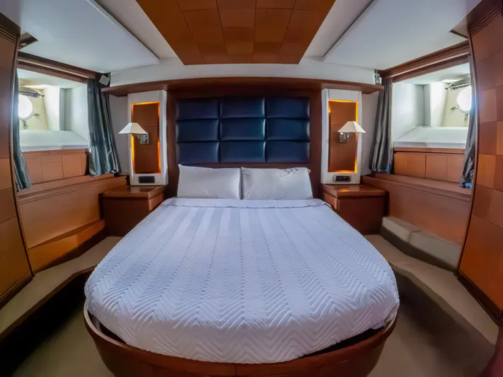 Camy Ed Yacht Photos Pics Luxurious bedroom interior of 2006 Azimut 105 Grande yacht with elegant wood paneling.