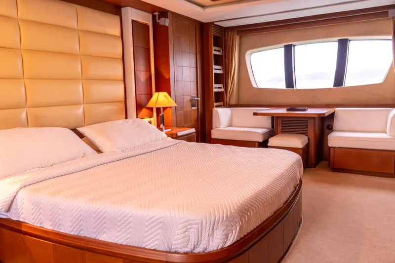 Camy Ed Yacht Photos Pics Luxurious bedroom interior of 2006 Azimut 105 Grande yacht with elegant furnishings.