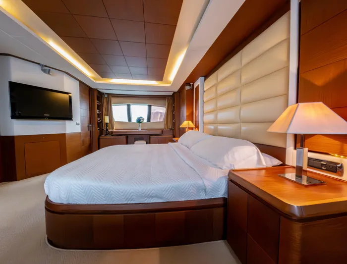 Camy Ed Yacht Photos Pics Luxurious bedroom interior on 2006 Azimut 105 Grande yacht, featuring elegant wood finishes.
