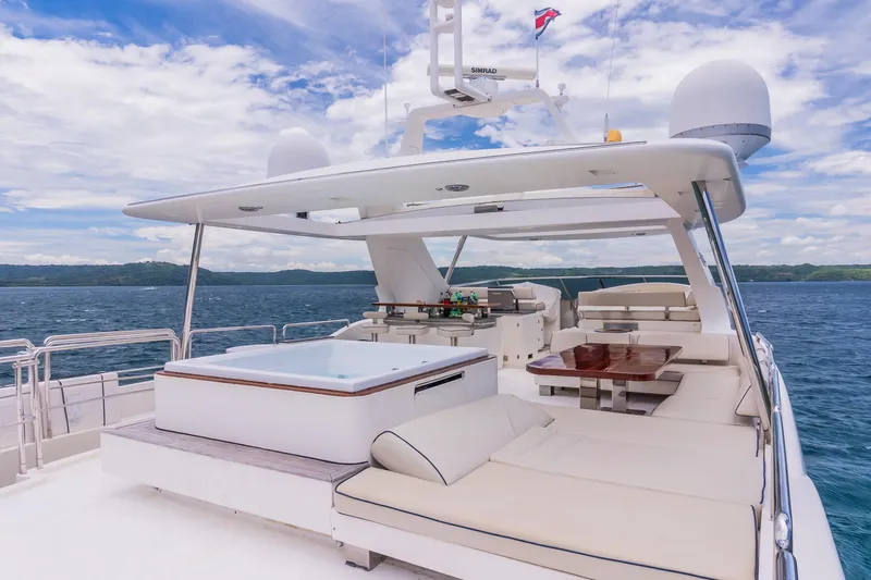 Camy Ed Yacht Photos Pics Luxurious 2006 Azimut 105 Grande yacht with spacious deck and seating, cruising on open water.