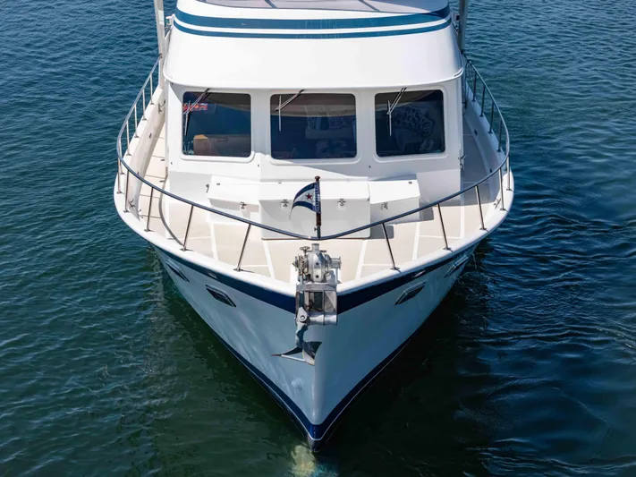 Si Como No Yacht Photos Pics Front view of a 2009 DeFever 45 Motoryacht on calm water.