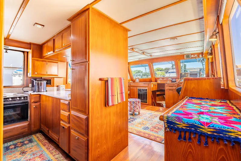 Si Como No Yacht Photos Pics Luxurious interior of 2009 DeFever 45 Motoryacht with wood finish and vibrant decor.