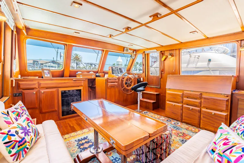 Si Como No Yacht Photos Pics Luxurious interior of 2009 DeFever 45 Motoryacht with wooden furnishings and vibrant decor.
