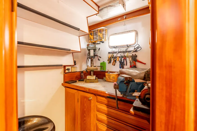 Si Como No Yacht Photos Pics Workshop area inside 2009 DeFever 45 Motoryacht with tools and wooden cabinetry.