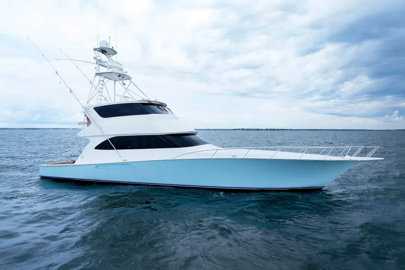 On Ice Yacht Photos Pics 2009 Viking 74 Enclosed Bridge yacht on open water under cloudy sky.