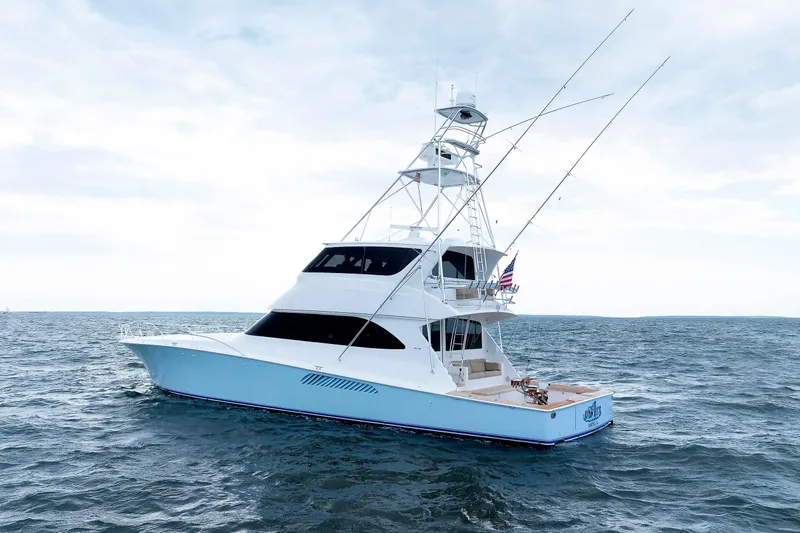 On Ice Yacht Photos Pics 2009 Viking 74 Enclosed Bridge yacht on open sea, showcasing sleek design and fishing equipment.