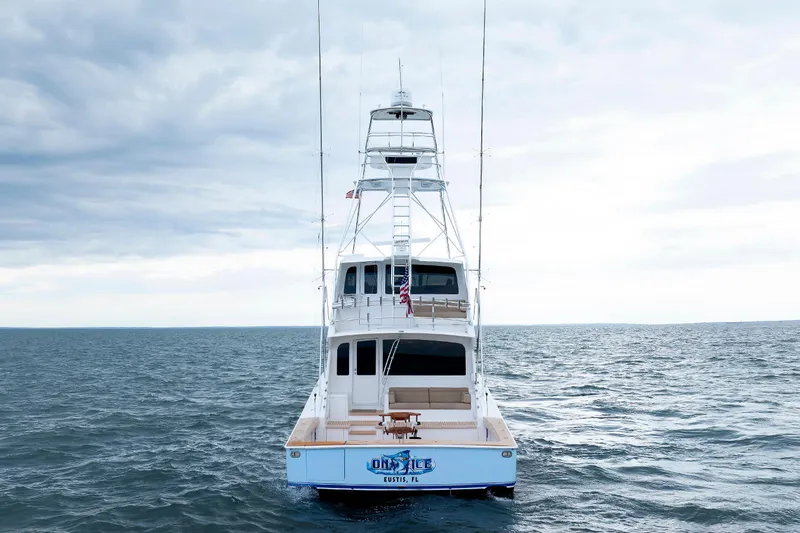 On Ice Yacht Photos Pics 2009 Viking 74 Enclosed Bridge yacht on open sea under cloudy sky.