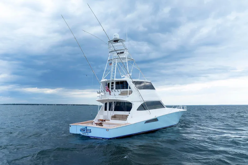 On Ice Yacht Photos Pics 2009 Viking 74 Enclosed Bridge yacht on open sea under cloudy sky.