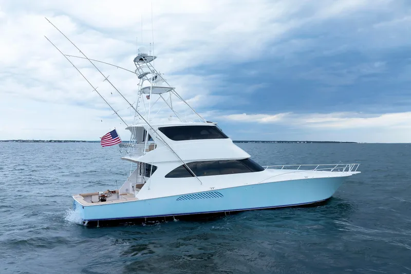 On Ice Yacht Photos Pics 2009 Viking 74 Enclosed Bridge yacht cruising on open water under cloudy skies.