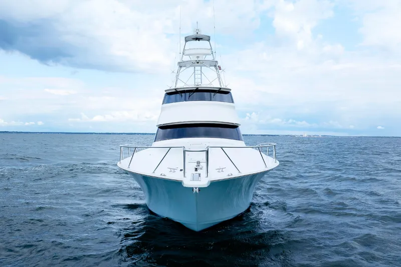 On Ice Yacht Photos Pics 2009 Viking 74 Enclosed Bridge yacht on open sea under cloudy sky.