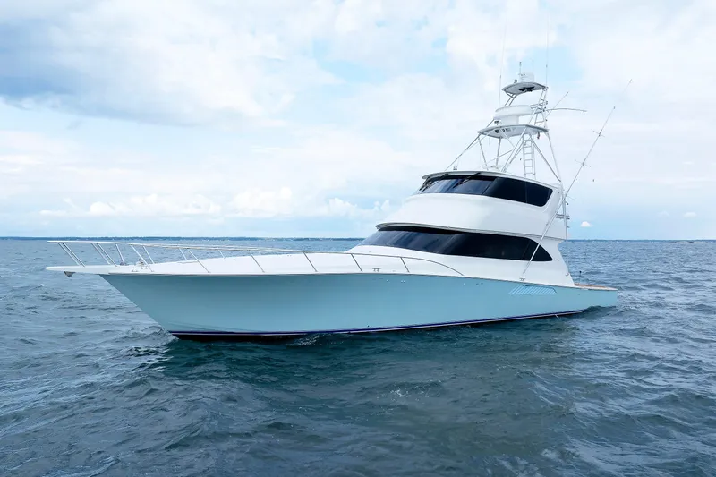 On Ice Yacht Photos Pics 2009 Viking 74 Enclosed Bridge yacht on open water under a cloudy sky.