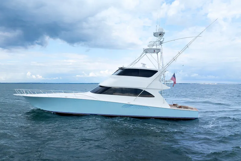 On Ice Yacht Photos Pics 2009 Viking 74 Enclosed Bridge yacht cruising on open water under cloudy skies.