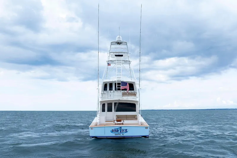On Ice Yacht Photos Pics 2009 Viking 74 Enclosed Bridge yacht on open sea under cloudy sky.