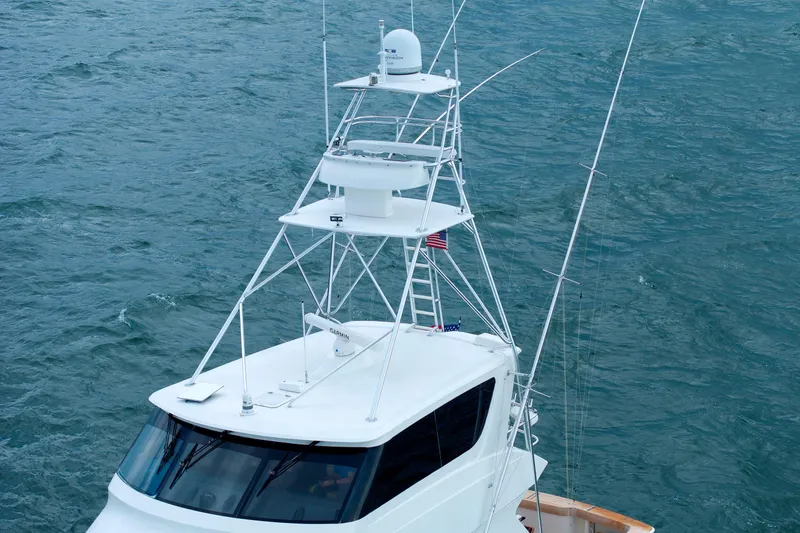 On Ice Yacht Photos Pics 2009 Viking 74 Enclosed Bridge yacht on open water, featuring a tall tower.