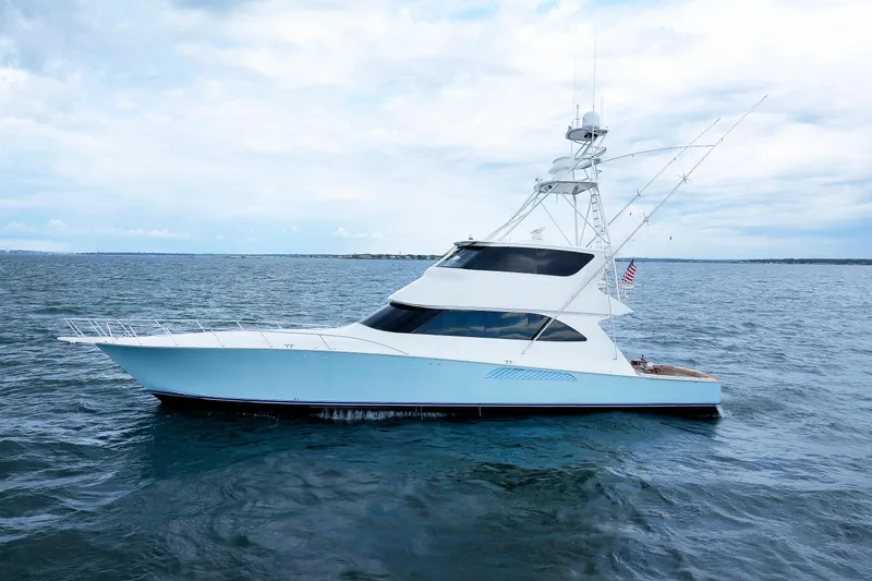 On Ice Yacht Photos Pics 2009 Viking 74 Enclosed Bridge yacht on open water under cloudy sky.