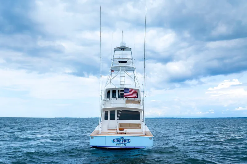 On Ice Yacht Photos Pics 2009 Viking 74 Enclosed Bridge yacht on open sea under cloudy sky.