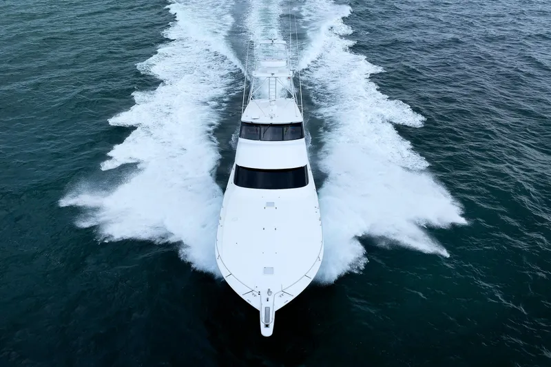 On Ice Yacht Photos Pics 2009 Viking 74 Enclosed Bridge yacht cruising on open water, aerial view.