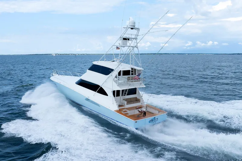 On Ice Yacht Photos Pics 2009 Viking 74 Enclosed Bridge yacht cruising on open sea under clear skies.