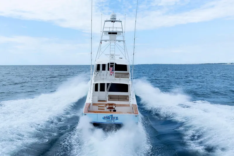 On Ice Yacht Photos Pics 2009 Viking 74 Enclosed Bridge yacht cruising on open sea, rear view.