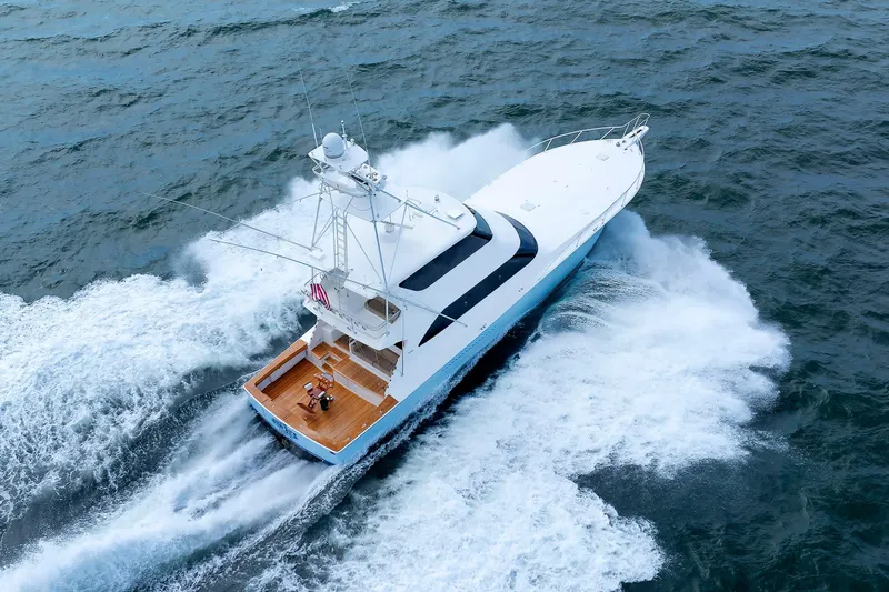 On Ice Yacht Photos Pics 2009 Viking 74 Enclosed Bridge yacht cruising on open water, aerial view.