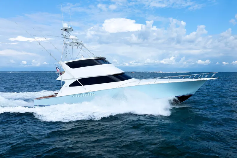 On Ice Yacht Photos Pics 2009 Viking 74 Enclosed Bridge yacht cruising on open sea under blue sky.