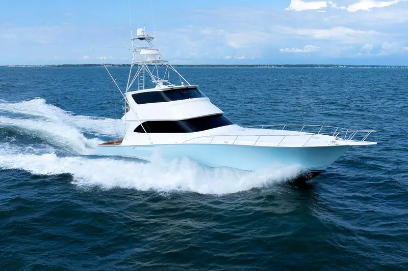 On Ice Yacht Photos Pics 2009 Viking 74 Enclosed Bridge yacht cruising on open sea under clear skies.