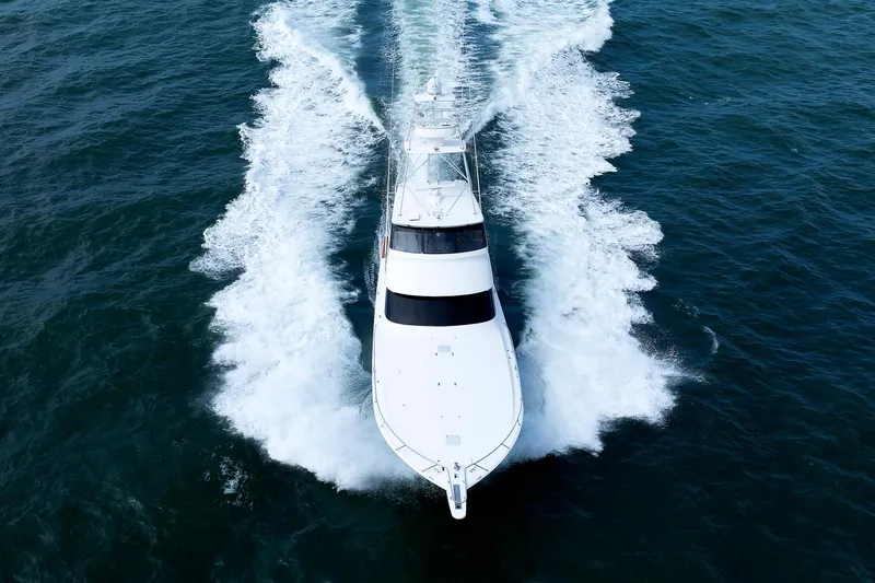 On Ice Yacht Photos Pics 2009 Viking 74 Enclosed Bridge yacht cruising on open water, aerial view.