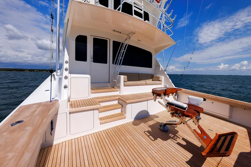 On Ice Yacht Photos Pics Luxurious 2009 Viking 74 Enclosed Bridge yacht with spacious deck and fishing chair on open sea.