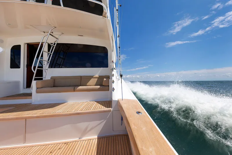 On Ice Yacht Photos Pics 2009 Viking 74 Enclosed Bridge yacht cruising on open sea under clear blue sky.