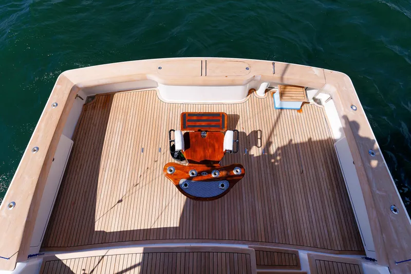 On Ice Yacht Photos Pics 2009 Viking 74 Enclosed Bridge yacht deck with wooden flooring and fishing chair.