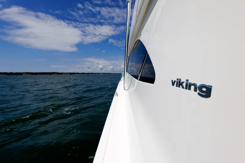 On Ice Yacht Photos Pics Side view of 2009 Viking 74 Enclosed Bridge yacht on open water.